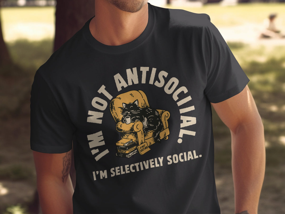 Black t-shirt with a graphic of a cat lounging on a chair, holding a mug, with text "I'M NOT ANTISOCIAL."