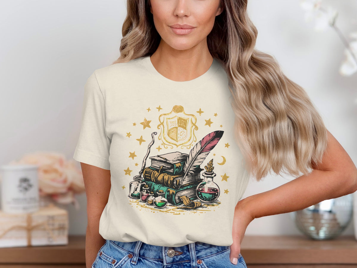 T-shirt with stack of books, feather quill, potion bottles, and magical crest.