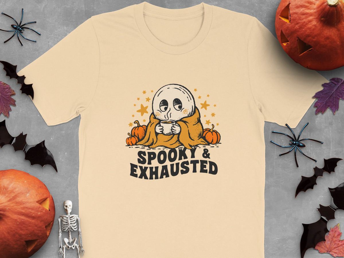 Peach t-shirt with a ghost, pumpkins, and text reading "SPOOKY & EXHAUSTED".