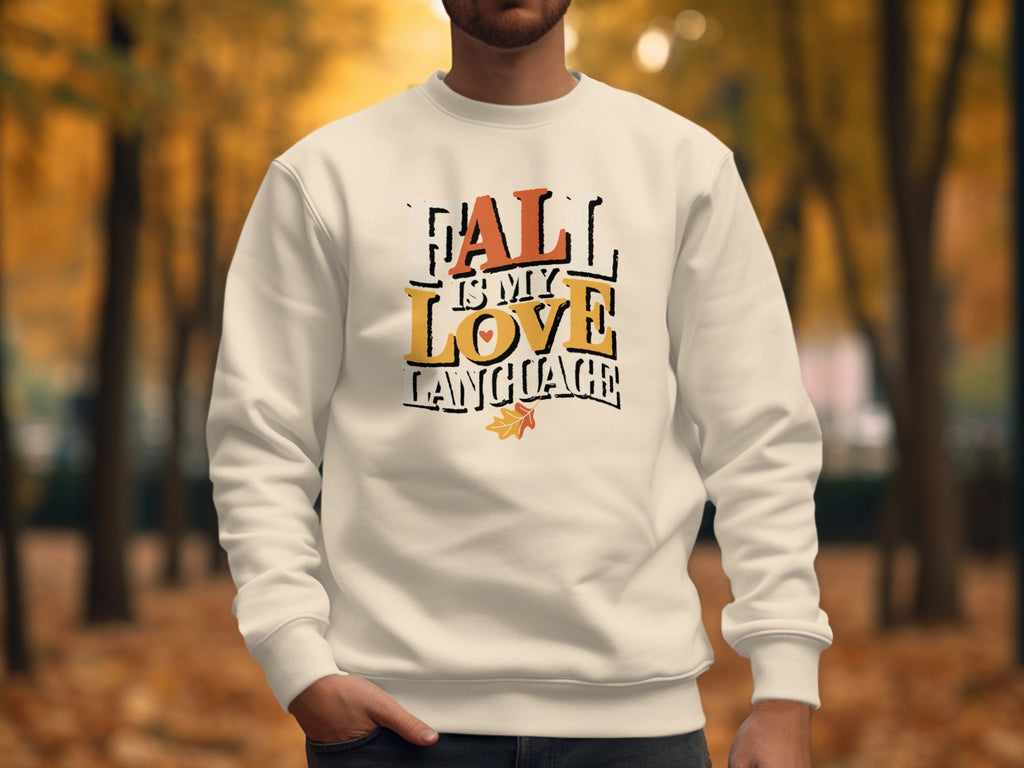 Cream sweatshirt with text "FALL IS MY LOVE LANGUAGE" and autumn leaf graphic.