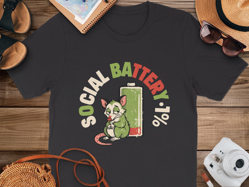 T-shirt with a tired opossum and "Social Battery 1%" graphic.