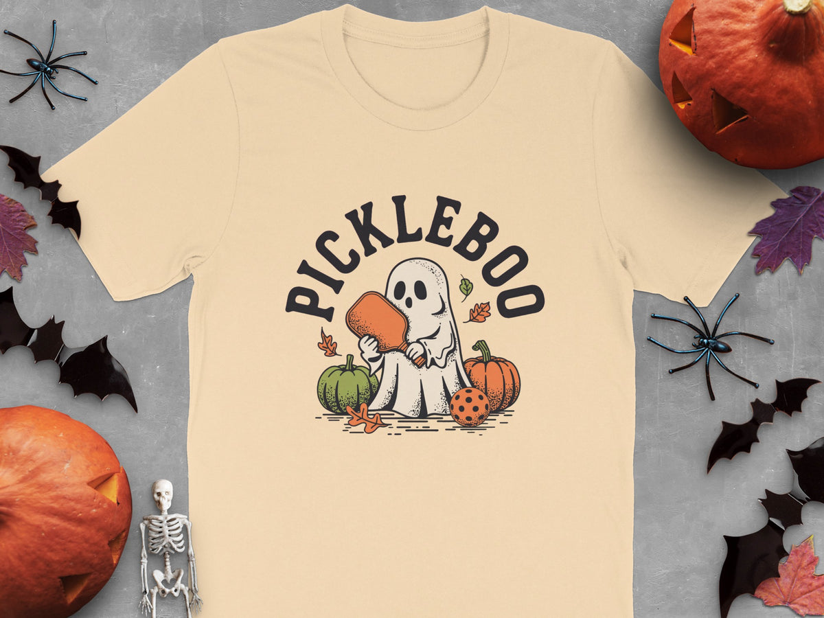 Ghost holding pickleball paddle and ball, with pumpkins and text "PICKLEBOO".