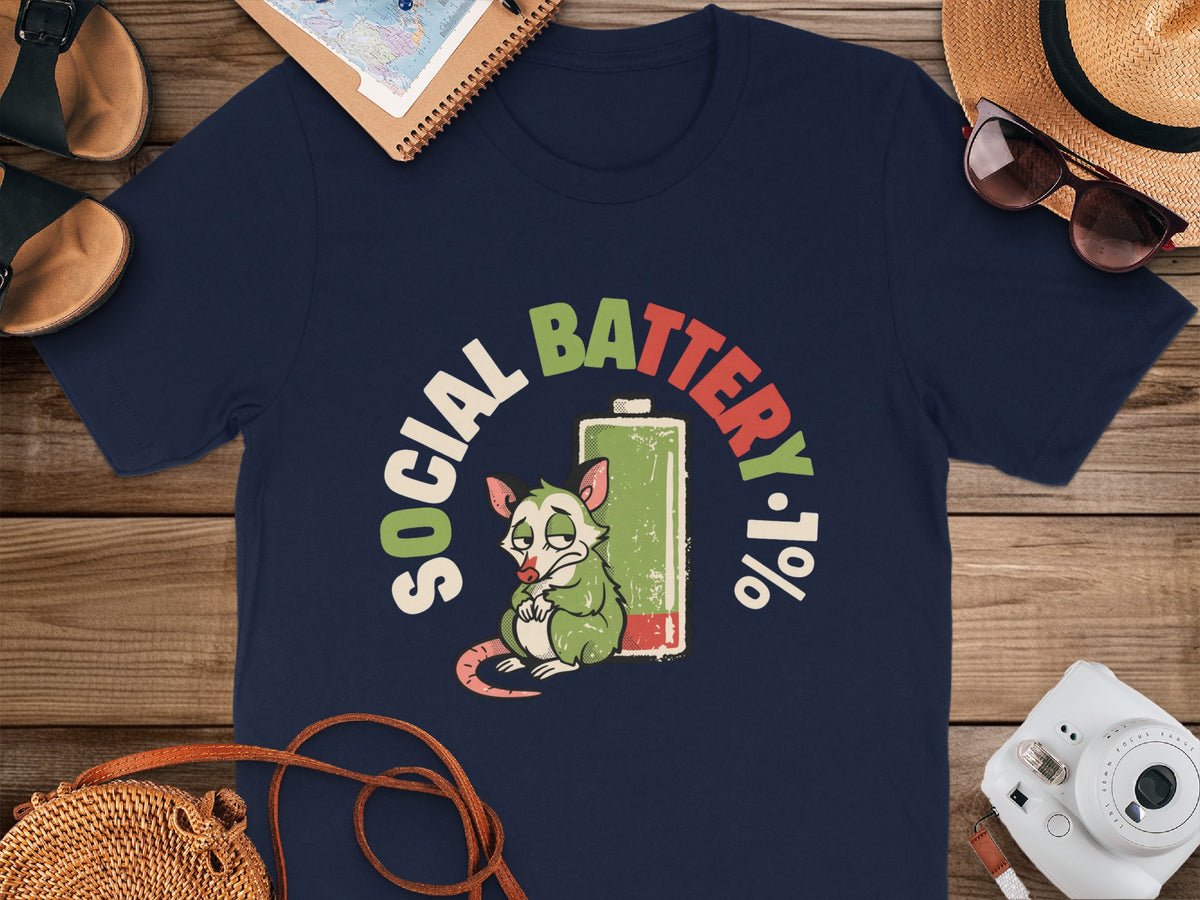 Navy t-shirt with a graphic of a possum and a low battery symbol saying "Social Battery 1%".