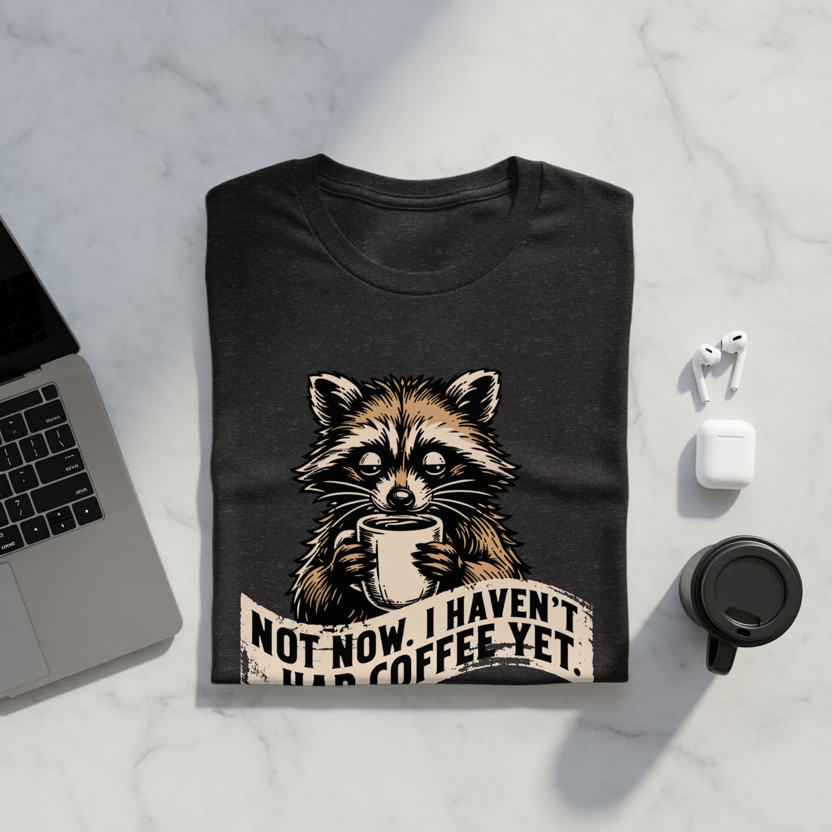 T-shirt with raccoon holding coffee mug and text "NOT NOW. I HAVEN'T HAD COFFEE YET."