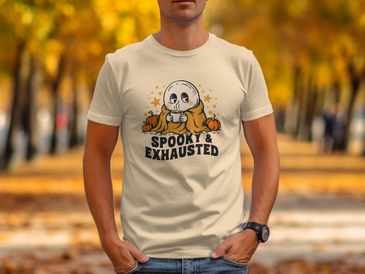 T-shirt with a ghost holding a coffee mug and pumpkins, text reads "Spooky & Exhausted."