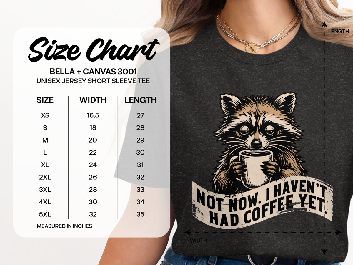Dark grey t-shirt with raccoon holding coffee cup and text "Not now. I haven't had coffee yet."