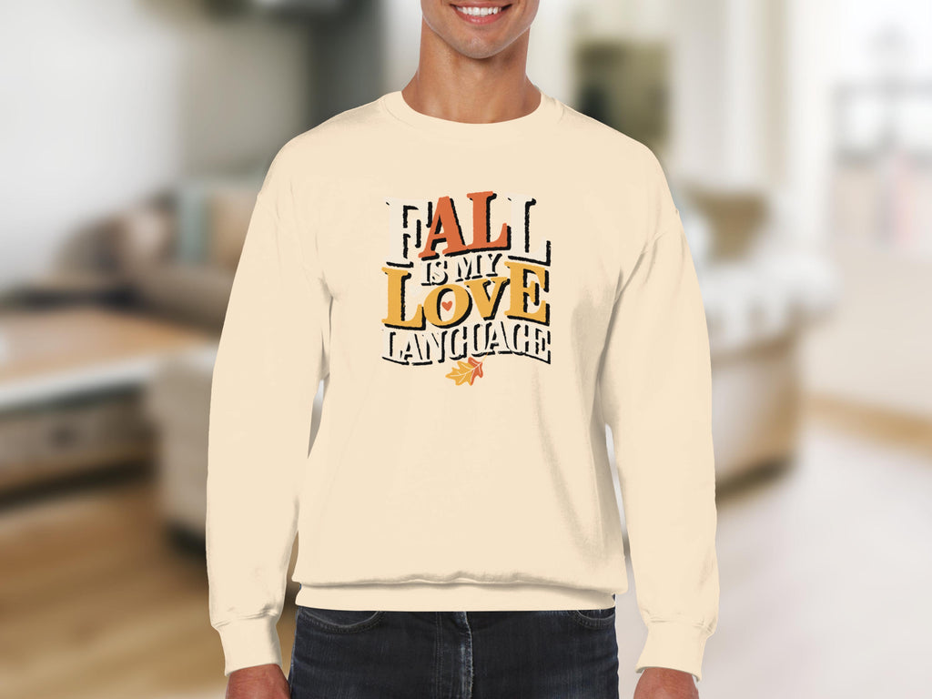Cream sweatshirt with "Fall is my love language" text and autumn leaf graphic.