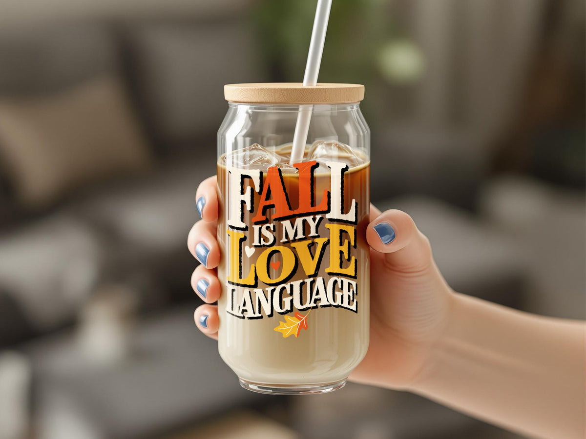 Clear glass can-shaped tumbler with lid and straw, says "Fall Is My Love Language".