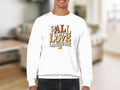 White sweatshirt with "Fall is my love language" graphic and leaf accent.