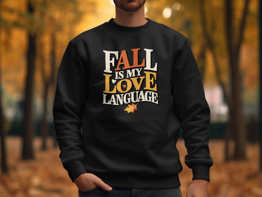 Black sweatshirt with "Fall is my love language" text and autumn leaf graphic.