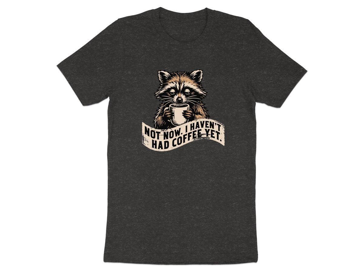Dark t-shirt with raccoon holding coffee mug and text "Not now. I haven't had coffee yet."