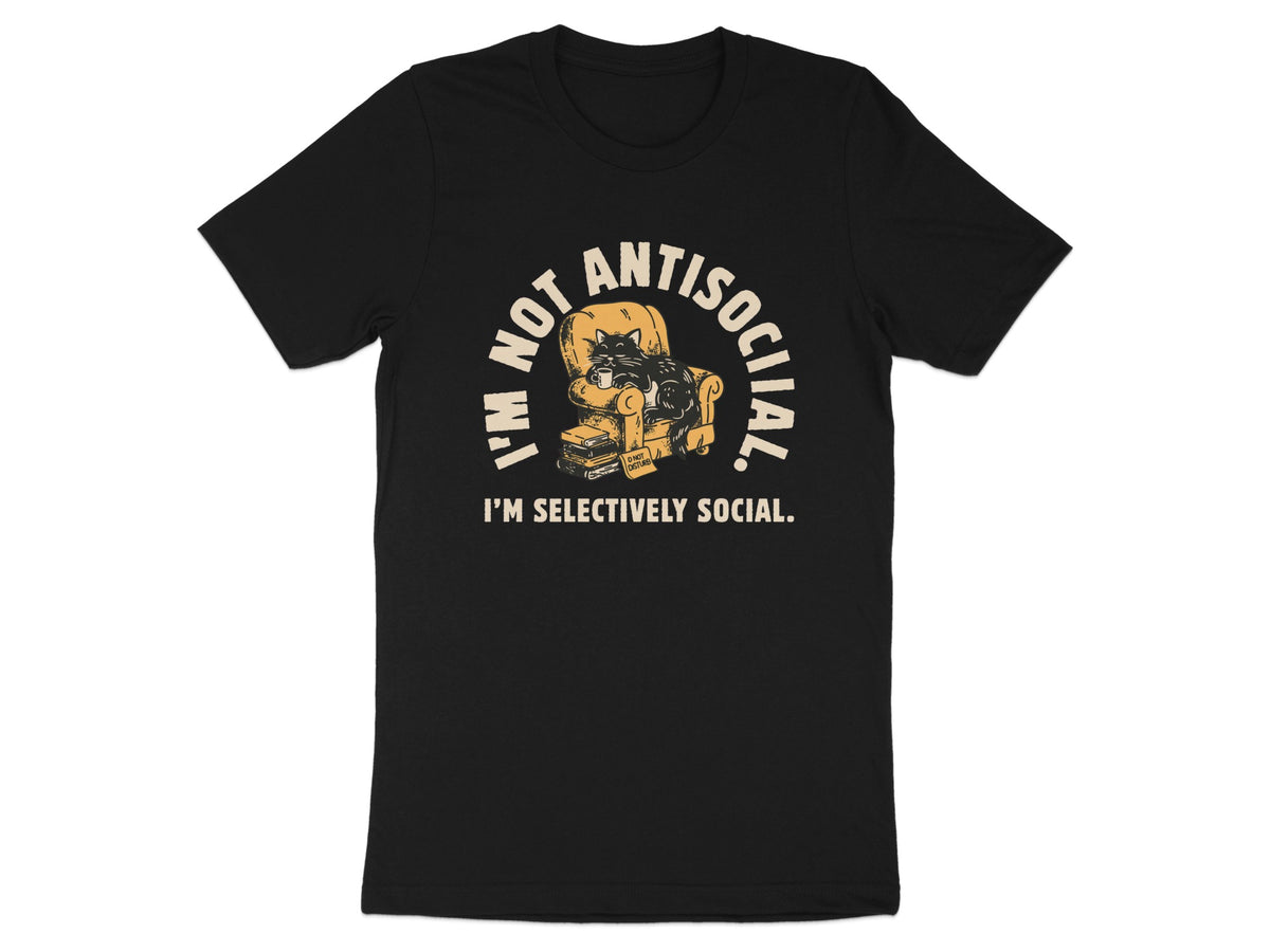 Black t-shirt with a cat sitting in a chair on books, text reads "I'm Not Antisocial. I'm Selectively Social."