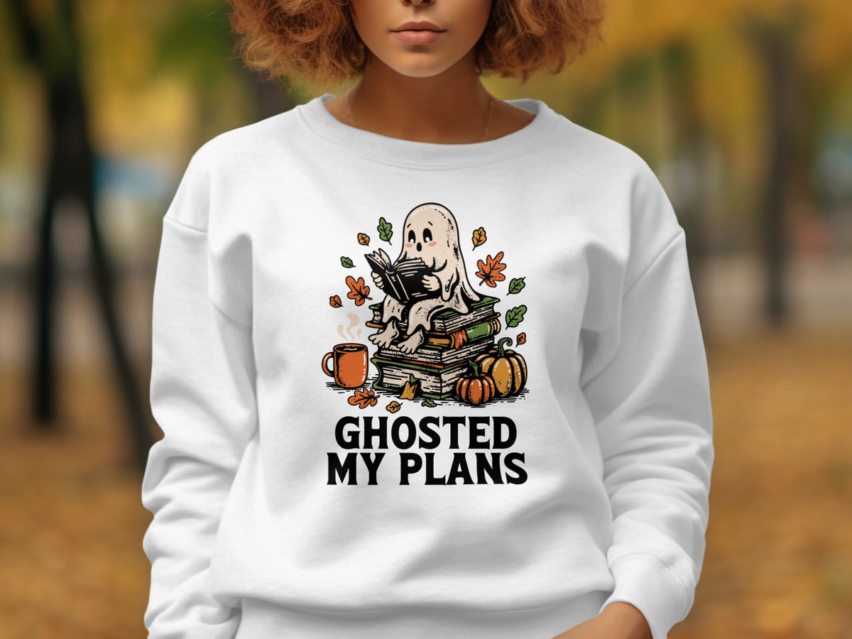 White sweatshirt with a ghost reading on books, text "GHOSTED MY PLANS".