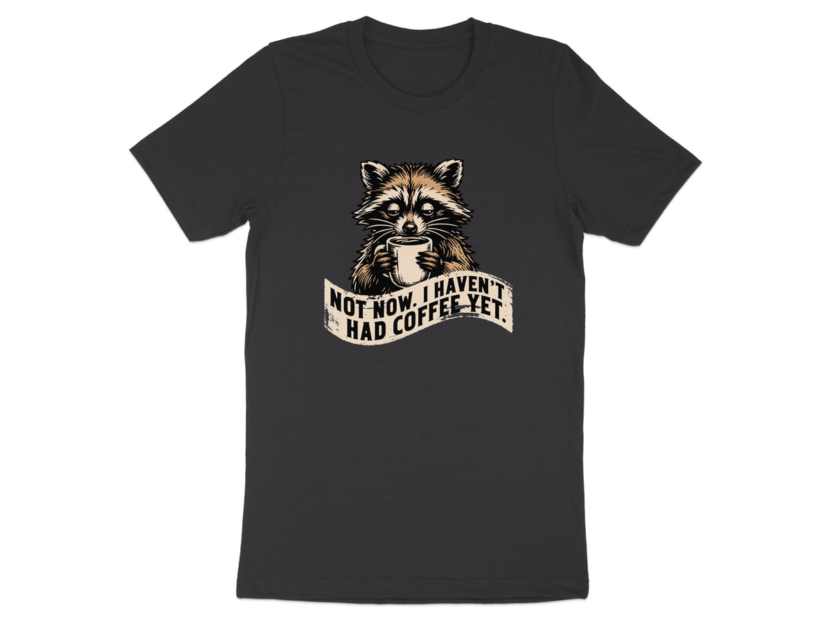 Raccoon holding coffee mug with text "Not now, I haven't had coffee yet."