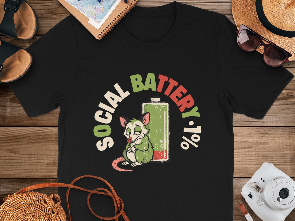 Black t-shirt with a sad possum and "Social Battery 1%" graphic.
