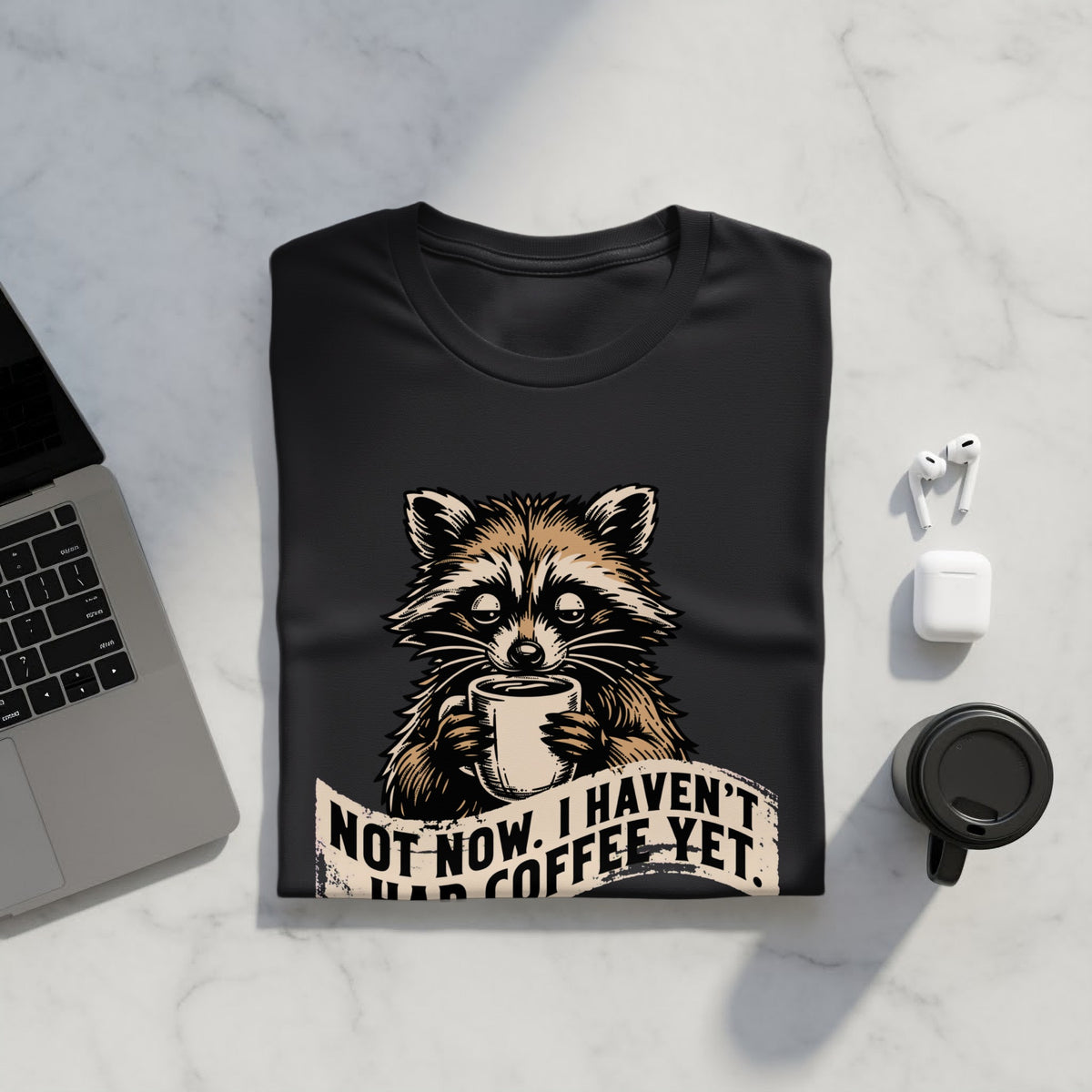 Black t-shirt with raccoon graphic and text "Not now, I haven't had coffee yet."