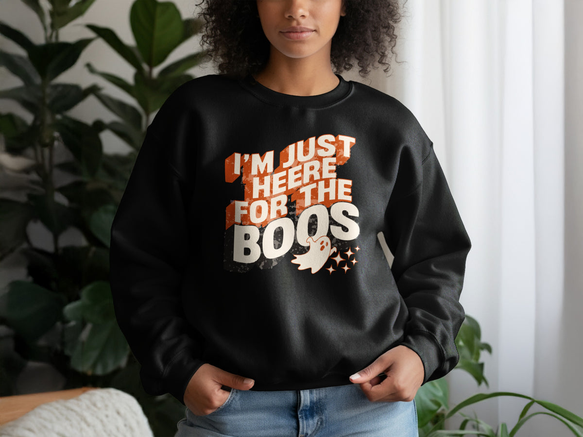 Black sweatshirt with text "I'M JUST HEERE FOR THE BOOS" and a ghost graphic.