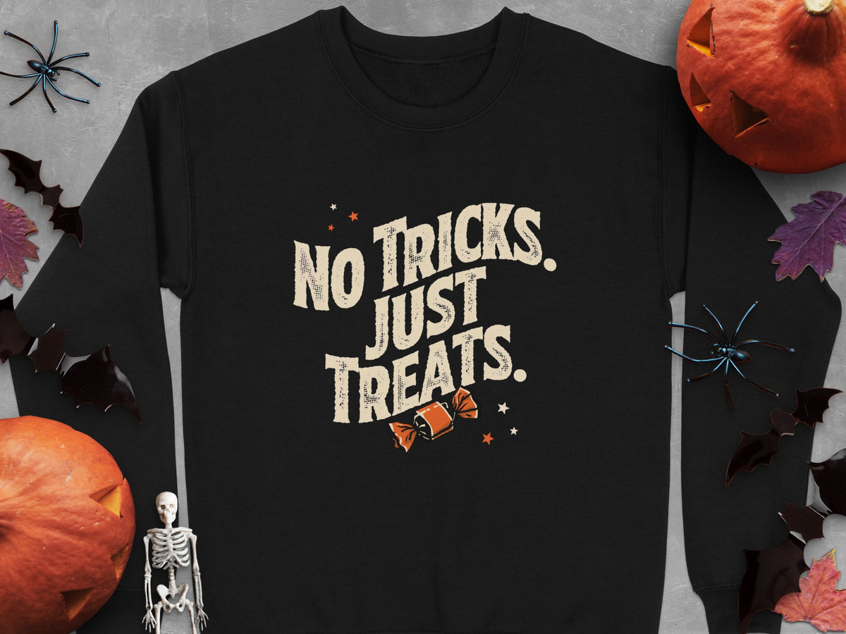 Black sweatshirt with "No Tricks. Just Treats." text and Halloween decorations.