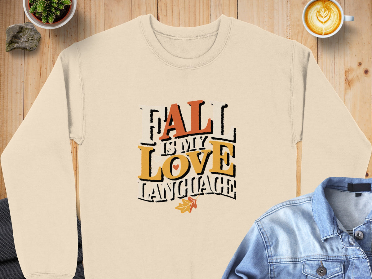 Cream sweatshirt with "Fall Is My Love Language" text and fall leaf graphic.