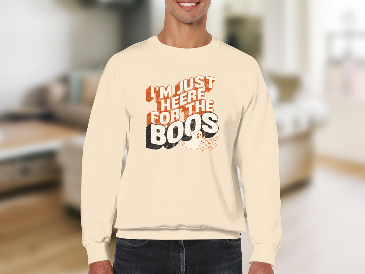 Cream sweatshirt with orange text "I'm just here for the boos" and a ghost.