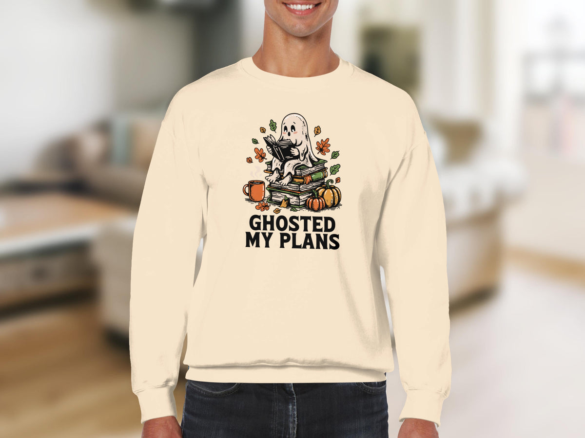 Cream sweatshirt with a ghost reading a book among pumpkins and leaves, text "Ghosted My Plans".