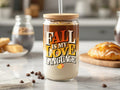 Glass tumbler with lid and straw featuring "Fall is my love language" text and autumn leaf graphics.