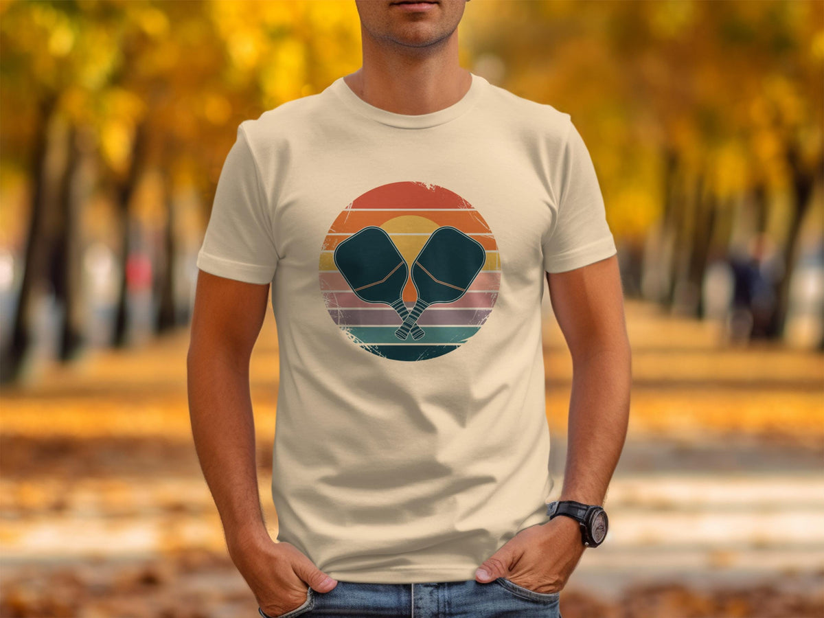 T-shirt with vintage pickleball paddles crossed in front of a sunset circle.