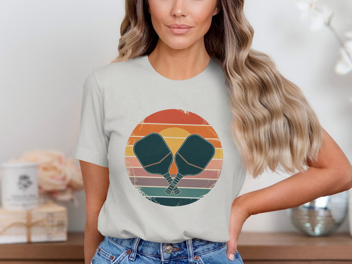 T-shirt with retro pickleball paddles and sunset graphic.
