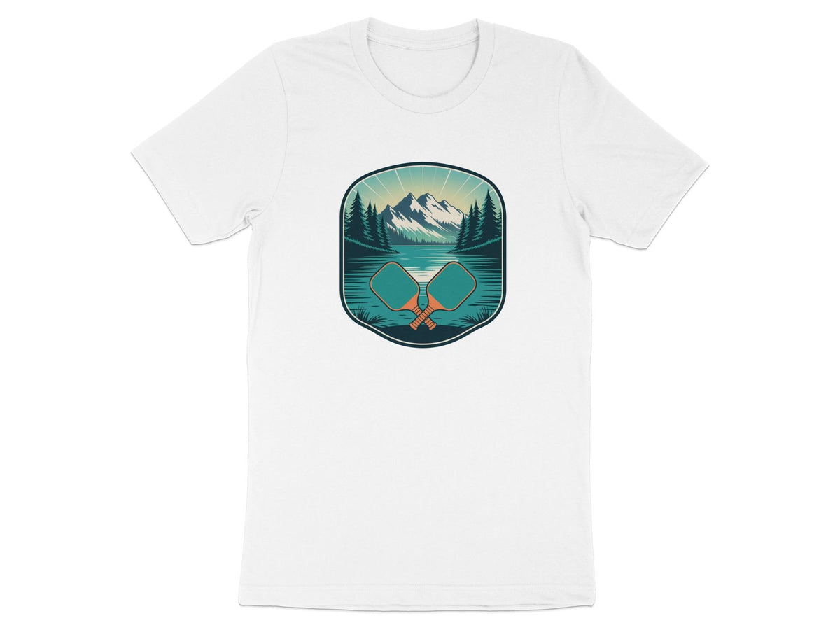 Two crossed pickleball paddles in front of a mountain and lake landscape.