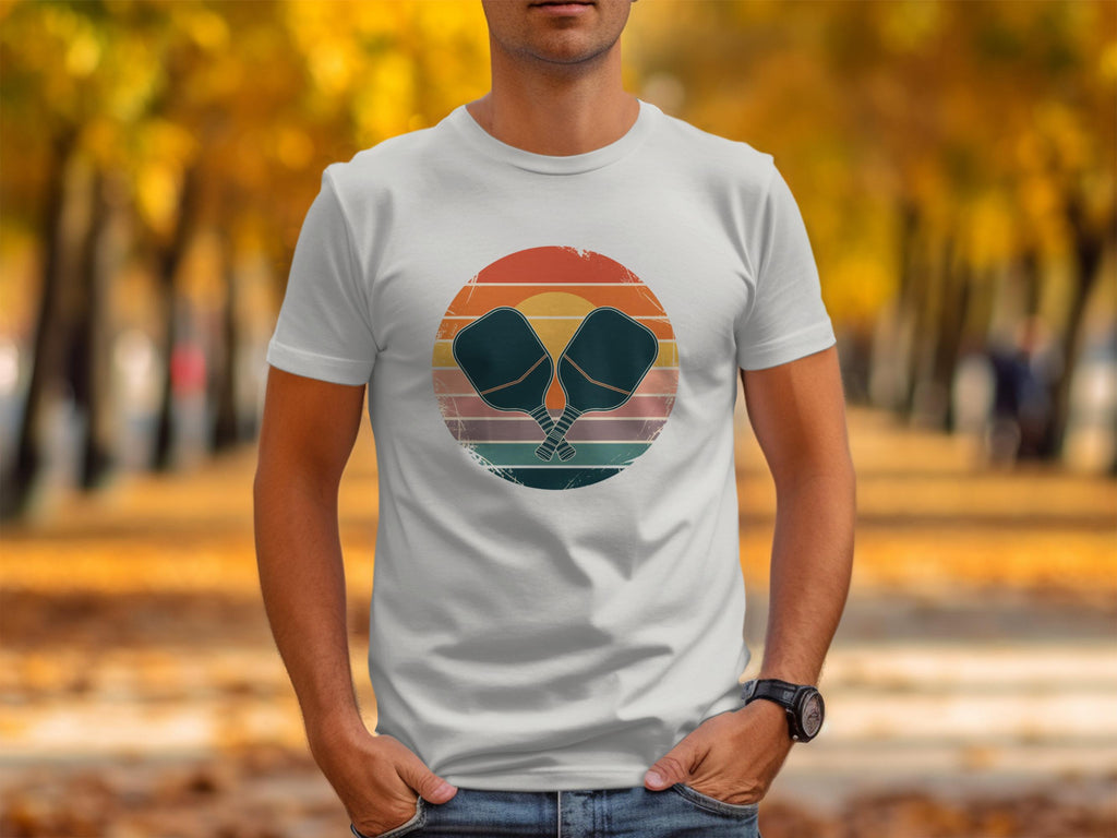 White t-shirt with vintage pickleball paddles and sunset graphic.